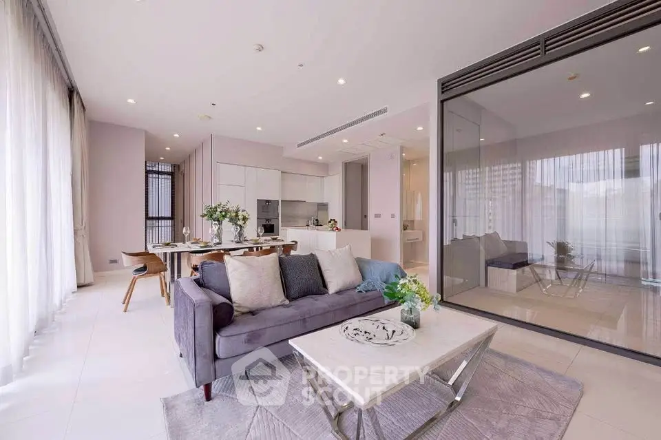 Luxurious open-plan living room with modern kitchen and elegant decor