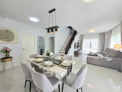 Spacious modern living and dining area with elegant decor and natural light.