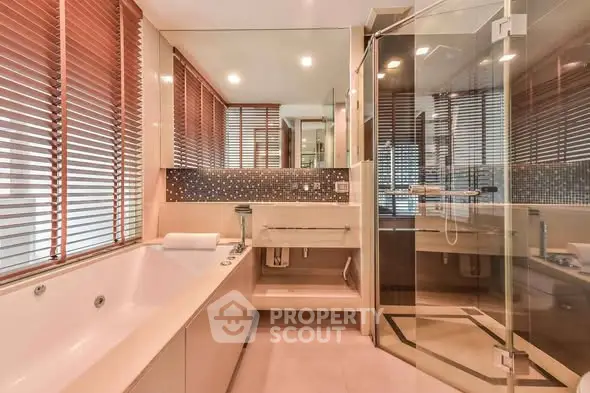 Luxurious bathroom with glass shower and modern bathtub