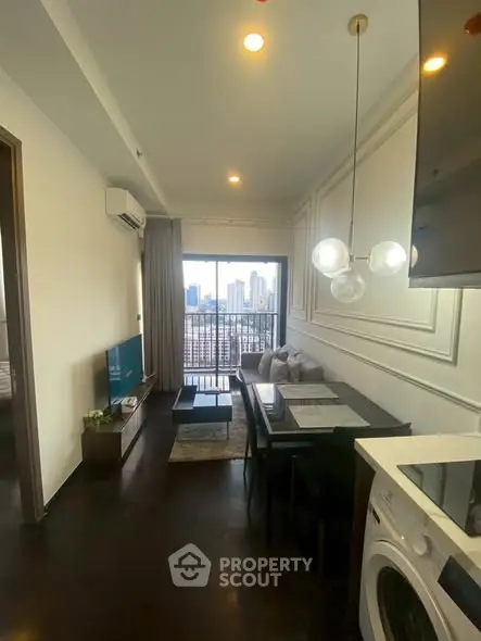 Modern living room with city view, stylish decor, and integrated kitchen appliances.