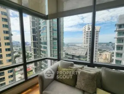 Stunning high-rise apartment with panoramic city views from a cozy living room corner.