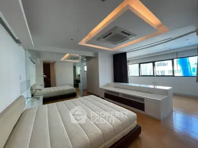 Spacious modern bedroom with large windows and elegant ceiling design
