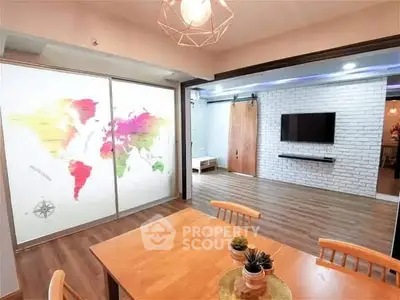 Stylish open living area with world map decor and modern TV setup