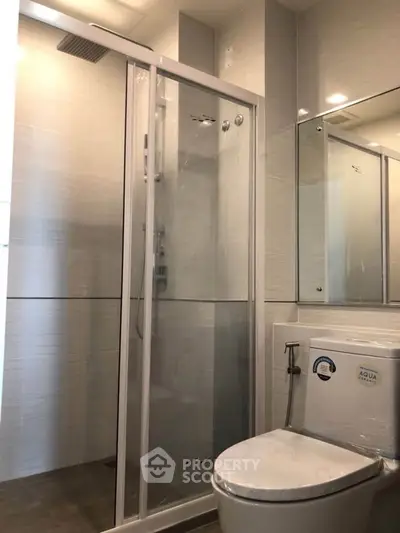 Modern bathroom with glass shower enclosure and sleek fixtures
