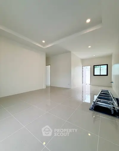 Spacious modern living room with glossy tiled floors and recessed lighting