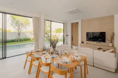 Luxurious open-plan living room with pool view and elegant dining area