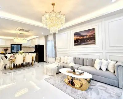 Luxurious open-plan living room with elegant chandeliers and modern decor