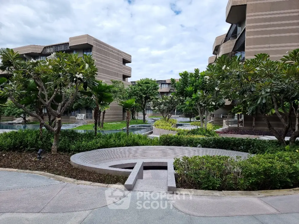 Luxurious modern apartment complex with lush landscaped gardens and contemporary architecture.