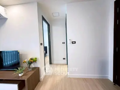 Modern minimalist living space with wooden flooring and sleek decor