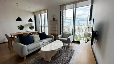 Modern living room with stunning city view, stylish furniture, and abundant natural light.