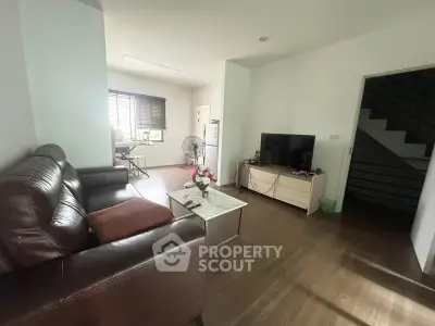 Spacious living room with leather sofa and modern decor in a bright, airy home.