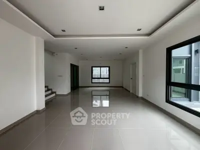 Spacious modern living room with sleek tile flooring and large windows