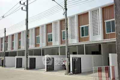 Modern townhouse exterior with gated parking and contemporary design