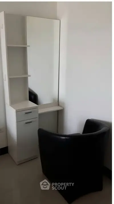 Modern minimalist corner with sleek chair and mirror in a stylish apartment.