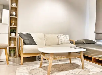 Modern living room with cozy sofa and stylish coffee table in bright interior.