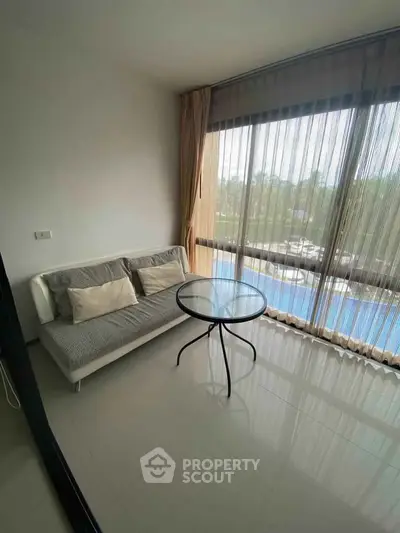 Cozy living room with pool view and modern furnishings