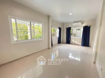 Spacious living room with large windows and natural light