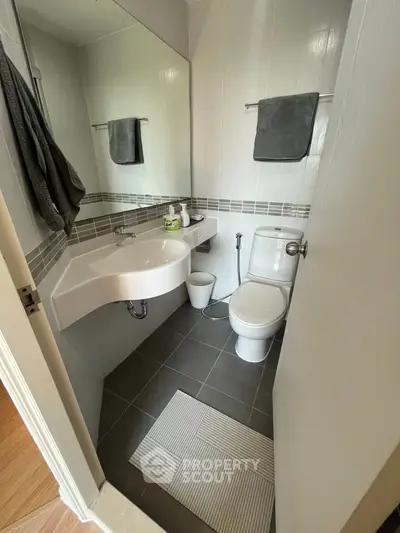 Modern bathroom with sleek fixtures and stylish tile design, perfect for contemporary living.