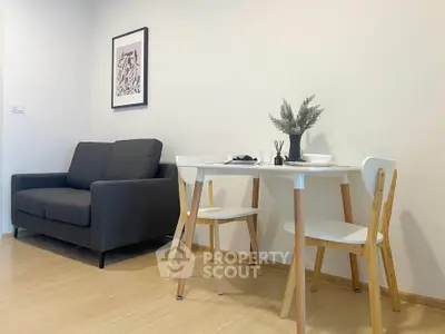 Modern living room with cozy sofa and stylish dining set, perfect for urban living.