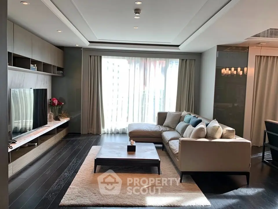 Luxurious modern living room with elegant decor and large windows for natural light.