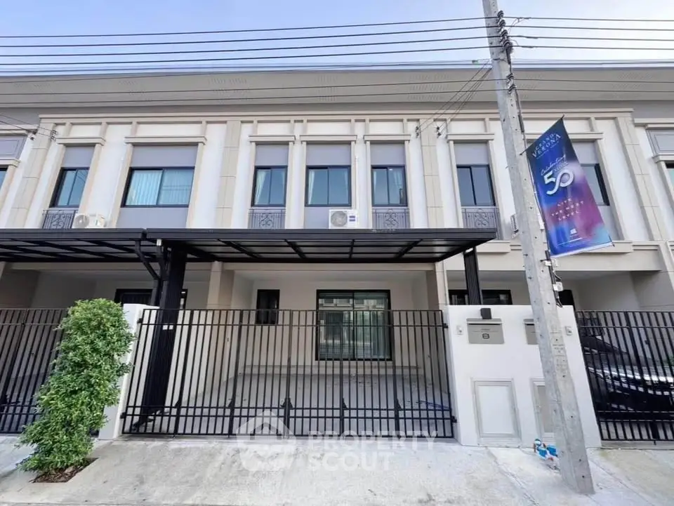 Modern townhouse exterior with gated parking and sleek design in a desirable neighborhood.