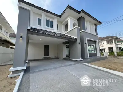 Modern two-story house with sleek gray exterior and spacious driveway