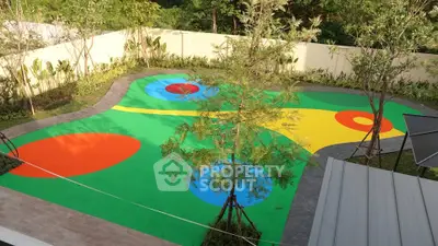 Vibrant garden with colorful abstract design and lush greenery