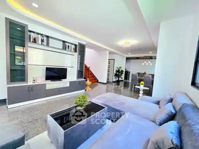 Spacious modern living room with sleek furniture and open dining area