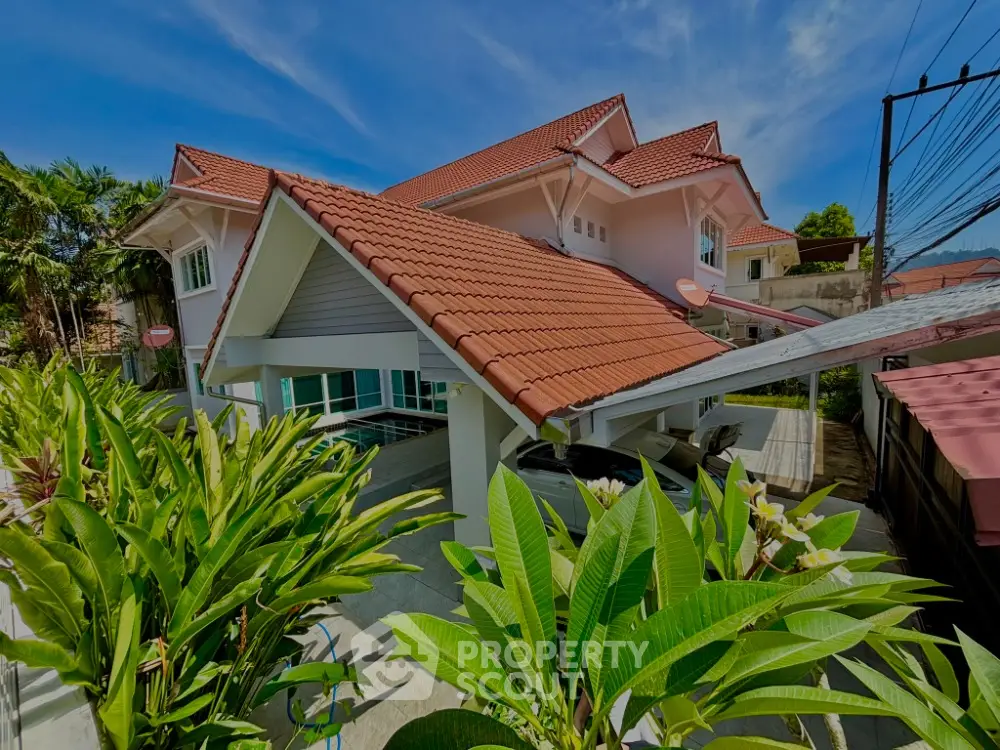 Charming suburban house with red-tiled roof and lush garden, perfect for family living.