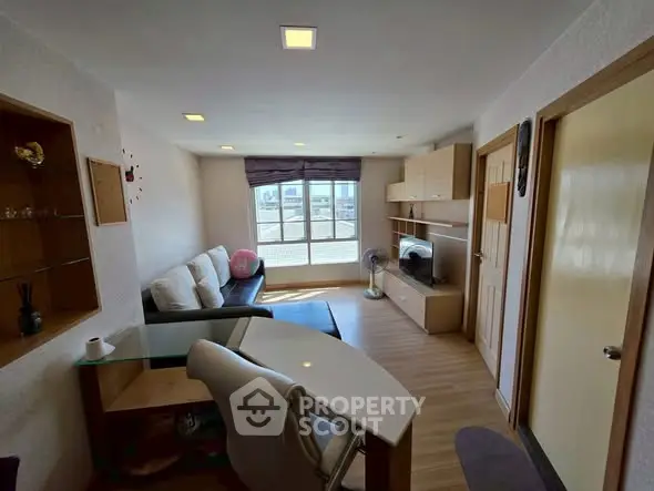 Cozy living room with modern furnishings and large window view