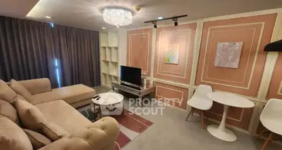 Elegant living room with plush sofa, modern decor, and stylish lighting in a cozy apartment.