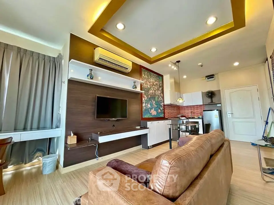 Modern living room with open kitchen, stylish decor, and cozy seating area.