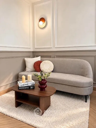 Stylish living room with modern sofa, elegant wall decor, and cozy coffee table setup.