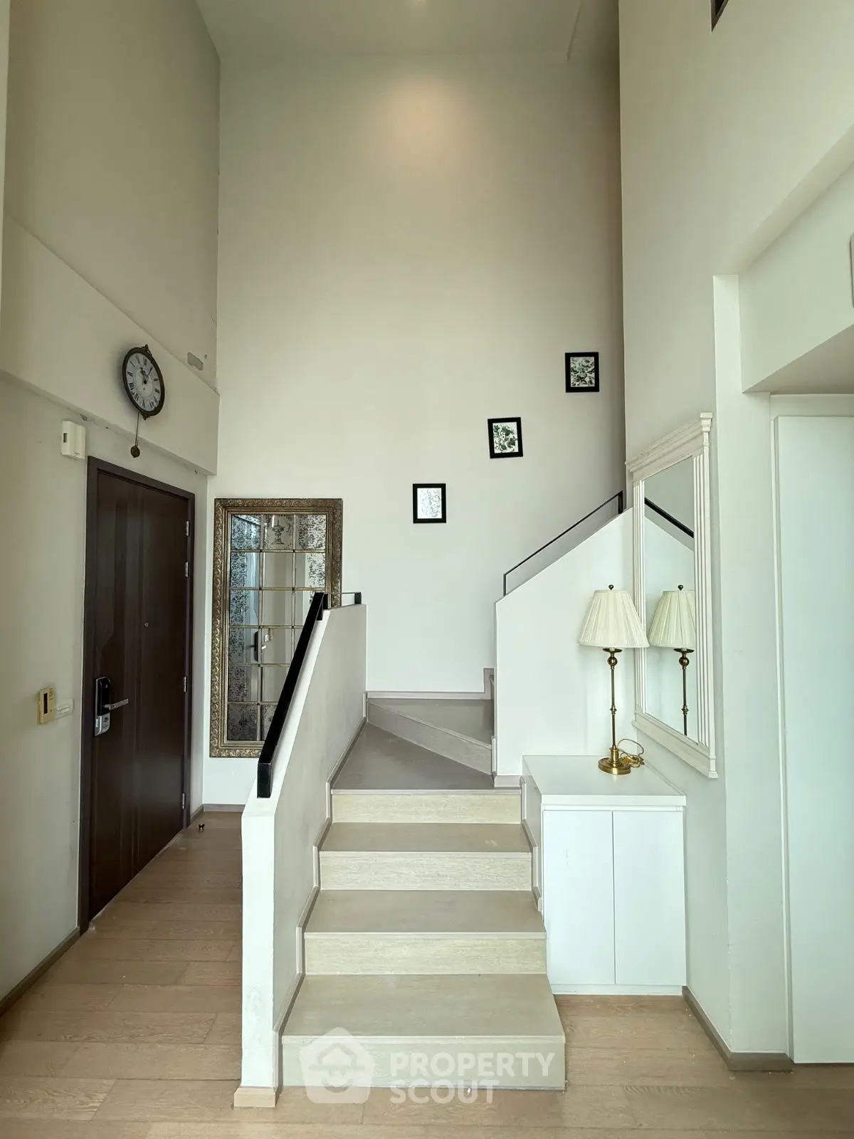 Elegant modern staircase with high ceilings and stylish decor