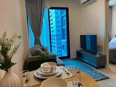 Modern living room with balcony view and stylish decor in urban apartment