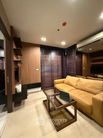 Modern living room with cozy beige sofa and sleek wooden accents