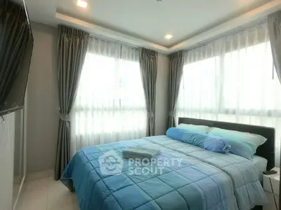 Bright and cozy bedroom with large windows and modern decor