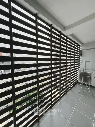 Modern balcony with sleek slatted design and city view, perfect for urban living.