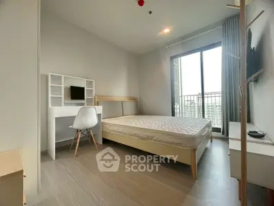Modern bedroom with minimalist furniture and large window balcony view.