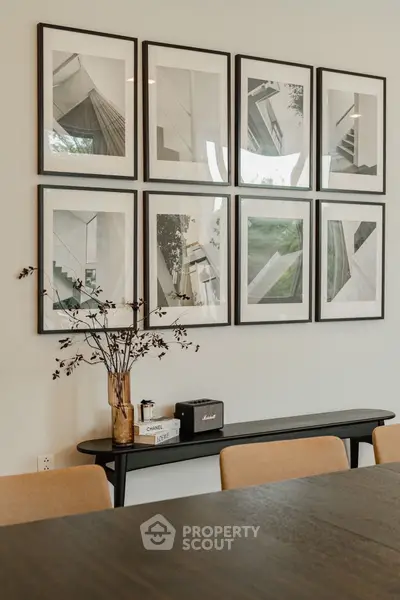 Elegant dining area with modern art and stylish decor, perfect for sophisticated gatherings.