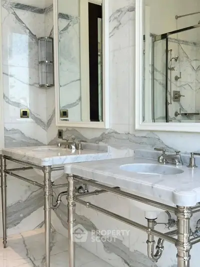 Luxurious marble bathroom with dual sinks and elegant fixtures