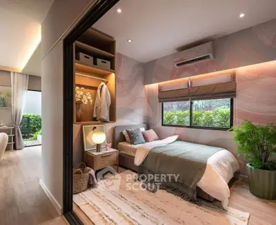 Modern bedroom with stylish decor and garden view, featuring cozy bedding and elegant lighting.