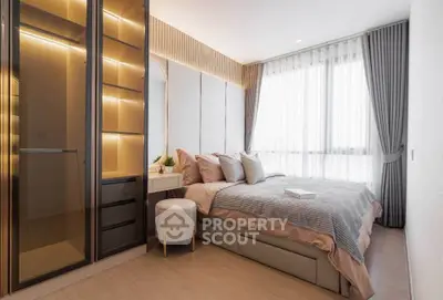 Luxurious bedroom with elegant decor and ample natural light, featuring a stylish wardrobe and cozy bed.