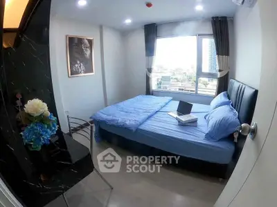 Modern bedroom with city view, featuring a comfortable bed and stylish decor, perfect for urban living.