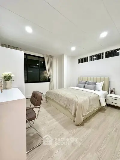Spacious modern bedroom with elegant decor and natural light