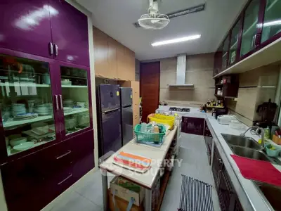 Spacious kitchen with modern appliances and ample storage in a stylish home.