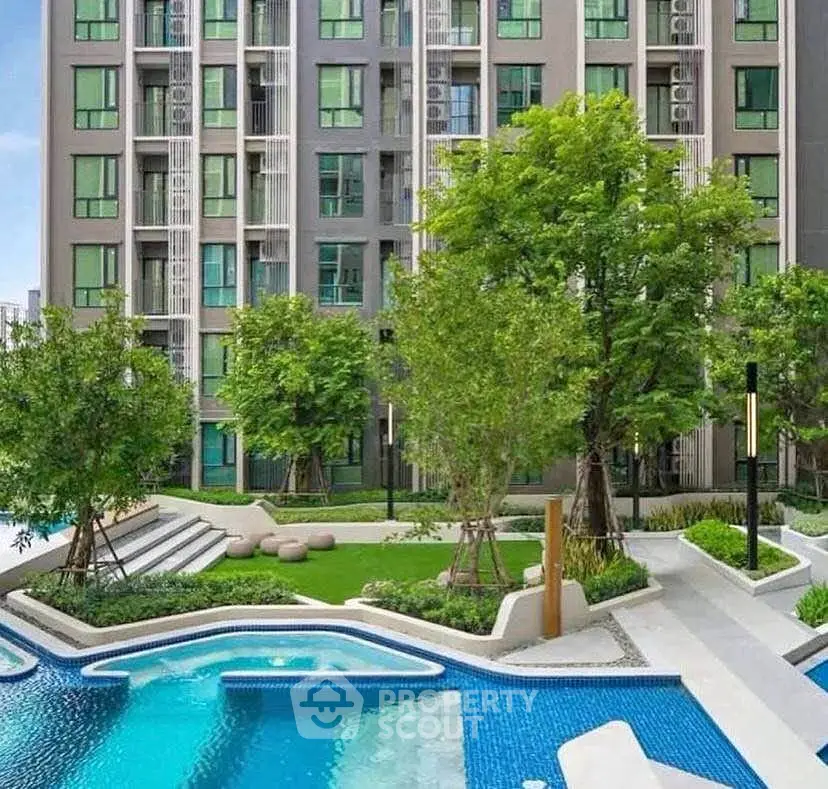 Modern apartment building with lush garden and inviting swimming pool.