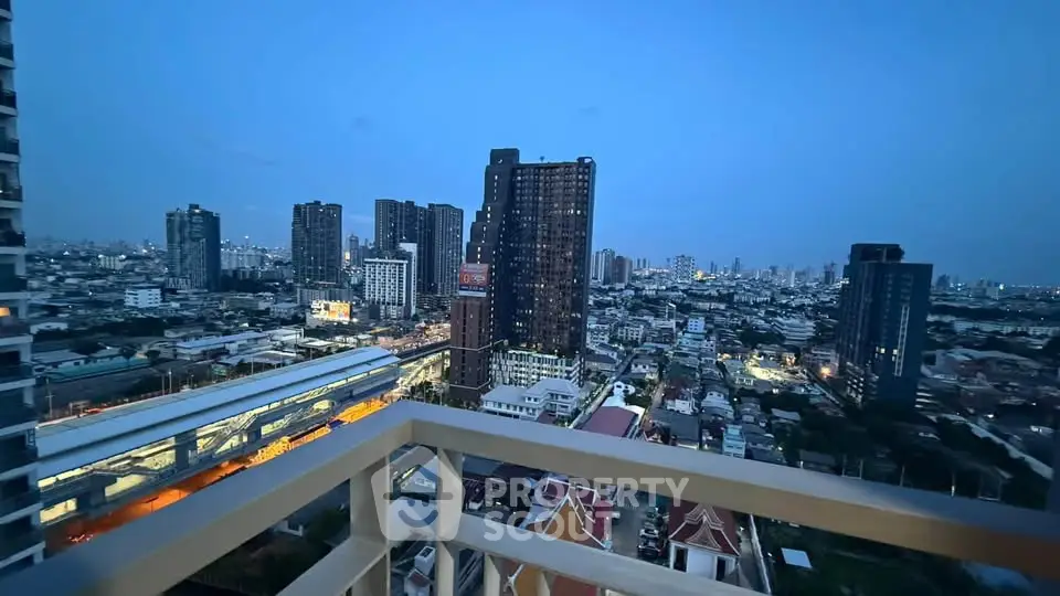 Stunning cityscape view from a high-rise balcony at dusk, showcasing urban skyline and vibrant city lights.
