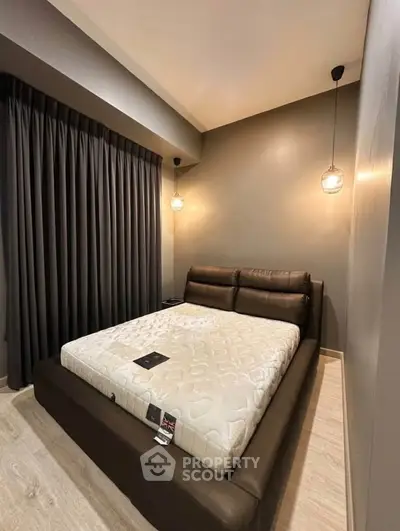 Modern bedroom with stylish lighting and elegant dark curtains