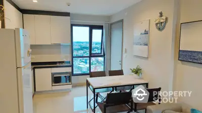 Modern kitchen with dining area and city view from window